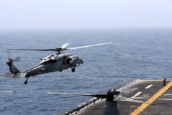 FILE - An MH-60S Sea Hawk lands on the flight deck of USS Boxer in the Arabian Sea off Oman, July 16, 2019.