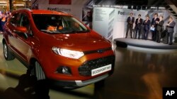 FILE - Russian Prime Minister Dmitry Medvedev, second right, attends the launch of Ford EcoSport production during a visit to Ford Sollers at a plant in Naberezhnye Chelny, about 700 kilometers (450 miles) east of Moscow, Dec. 2, 2014.