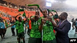 Nigeria's players celebrate the victory at the end of the Africa Cup of Nations (CAN) 2024 semifinal football match between Nigeria and South Africa at the Stade de la Paix in Bouake on February 7, 2024. 