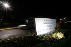 FILE - A car drives past the sign for vaccine developer Novavax at the company's headquarters in Gaithersburg, Maryland, Nov. 30, 2020.