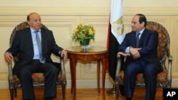 President Abed Rabbo Mansour Hadi, right, meets with Egyptian President Abdel Fattah al-Sissi after his arrival to attend an Arab summit in Sharm el-Sheikh, March 27, 2015.