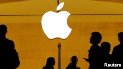 ARCHIVO - Clientes pasan frente a un logotipo de Apple dentro de una tienda Apple en la Gran Estación Central en Nueva York, EEUU, el 1 de agosto de 2018. 