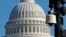 FILE - Surveillance cameras are visible near the U.S. Capitol in Washington.
