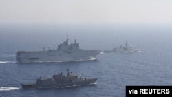 Greek and French vessels sail in formation during a joint military exercise in the Mediterranean Sea, in this undated handout image obtained by Reuters on Aug. 13, 2020. 