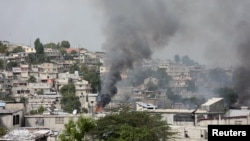 FILE - A house set ablaze by gangs burns amid ongoing violence in Port-au-Prince, Haiti, Feb. 26, 2025. Violence continued on Tuesday, when armed gangs attacked the Carrefour Feuilles neighborhood of Port-au-Prince.