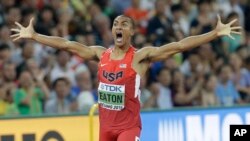 United States' Ashton Eaton celebrates as he crosses the finish line after his decathlon 400m race at the World Athletics Championships at the Bird's Nest stadium in Beijing, Aug. 28, 2015. 
