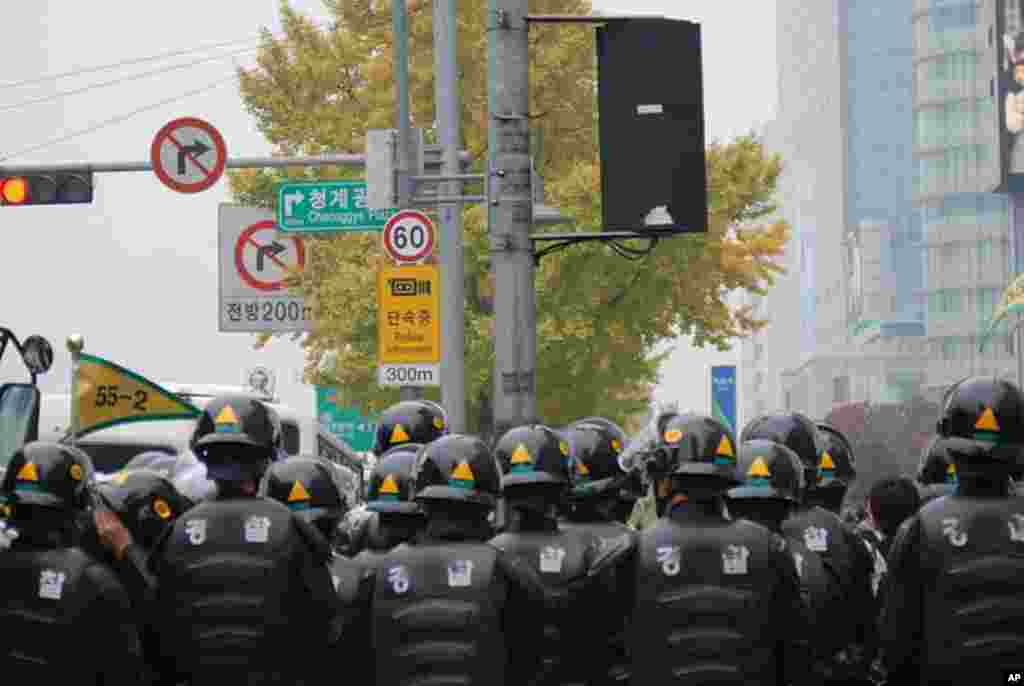 A riot police squad standing by in downtown Seoul.