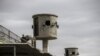 A picture taken during a guided tour organized by Egypt's State Information Service on Feb. 11, 2020, shows an Egyptian policeman near watch towers at Tora prison in the Egyptian capital Cairo.