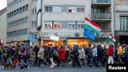 FILE - People attend a rally for the Soros-founded Central European University in Budapest, Hungary, Nov. 24, 2018. 