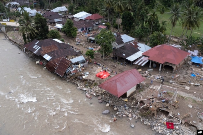 Homes damaged by a flash flood sit in Pesisir Selatan, West Sumatra, Indonesia, Wednesday, March 13, 2024. (AP Photo/Sutan Malik Kayo)