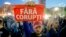 A man holds a poster that reads "Without Corruption" during a protest in Bucharest, Romania, May 3, 2017. 
