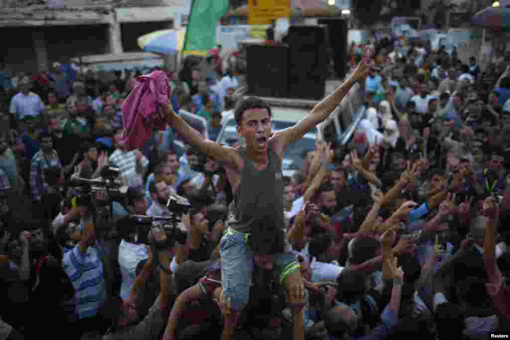 Palestinians celebrate following announcement of a cease-fire in Gaza City Aug. 26, 2014. 