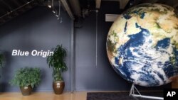 FILE - The lobby of space venture Blue Origin features a replica of the Earth, March 8, 2016, in Kent, Wash. On Wednesday, the company sent a capsule to an altitude of 74 miles.