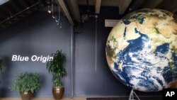  FILE - The lobby of space venture Blue Origin features a replica of the Earth, March 8, 2016, in Kent, Washington. 