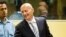 Bosnian Croat Jadranko Prlic, right, shakes hands with his lawyer prior to his judgment at the Yugoslav war crimes tribunal (ICTY) in The Hague, Netherlands, May 29, 2013. 