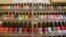 FILE - A wall rack is filled with nail polishes, Nov. 30, 2016, at a salon in Alameda, Calif. A group of Vietnamese-American salon owners in Louisiana accused the state of racial bias and received a $100,000 settlement.