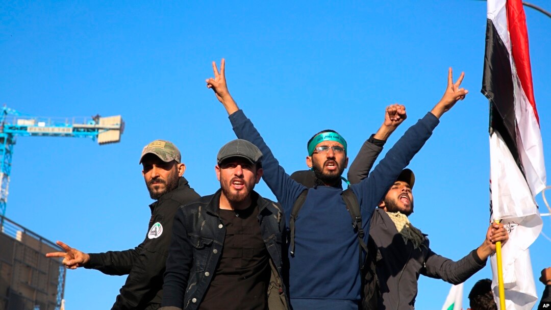 Mourners escort the flag-draped coffin of Abu Mahdi al-Muhandis, deputy commander of Iran-backed militias during his funeral procession in Basra, Iraq, Tuesday, Jan. 7, 2020.