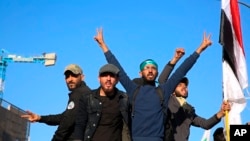 Mourners escort the flag-draped coffin of Abu Mahdi al-Muhandis, deputy commander of Iran-backed militias during his funeral procession in Basra, Iraq, Tuesday, Jan. 7, 2020.