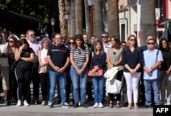 Attendees stand during a minute of silence on October 2, 2023, in Murcia, Spain, one day after a fire in two adjoining discos killed at least 13 people.