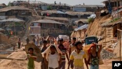 Rohingya refugees rebuild their makeshift houses, in preparation for the approaching monsoon season at the Kutupalong Rohingya refugee camp in Kutupalong, Bangladesh, April 28, 2018. Rohingya refugees who fled Myanmar during a brutal crackdown now face a new danger: rain. The annual monsoon will soon sweep through camps where some 700,000 Rohingya Muslims live in huts made of bamboo and plastic built along steep hills.