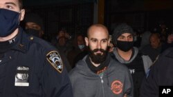 FILE - Mac's Public House co-owner Danny Presti is taken away in handcuffs after being arrested by New York City sheriff's deputies, Dec. 1, 2020, in the Staten Island borough of New York.