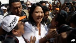 FILE - Presidential candidate Keiko Fujimori, center, of the Fuerza Popular political party, greets supporters as she campaigns in the San Juan de Lurigancho shantytown on the outskirts of Lima, Peru, May 10, 2016. 