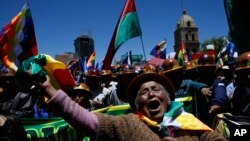 A supporter of Bolivian President Evo Morales marches in La Paz, Bolivia, Oct. 23, 2019. Morales said Wednesday his opponents are trying to stage a coup against him as protests grow over a disputed election he claims he won outright.