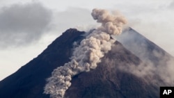 Hot cloud of volcanic materials run down the slope of Mount Merapi during an eruption in Sleman, Wednesday, Jan. 27, 2021. Indonesia's most active volcano erupted Wednesday with a river of lava and searing gas clouds flowing 1,500 meters (4,900 feet…