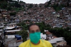 A man wears a mask to protect himself against the spread of the new coronavirus as he donates food for poor families in Turano favela, Rio de Janeiro, Brazil, April 15, 2020.