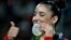 FILE - United States' Aly Raisman displays her silver medal for floor during the artistic gymnastics women's apparatus final at the 2016 Summer Olympics in Rio de Janeiro, Brazil, Tuesday, Aug. 16, 2016.