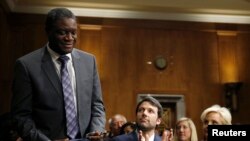 Actor, writer and director Ben Affleck, center, and Cindy McCain, right, applaud Denis Mukwege, left, Medical Director of the Panzi Hospital in the Congo, at the Senate Foreign Relations Committee, Capitol Hill, Washington, Feb. 26, 2014.