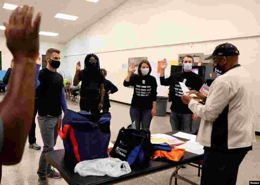 Poll workers take an oath at the Fulton County polling station during the election, in Atlanta, Georgia.