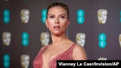 FILE - Scarlett Johansson arrives at the Bafta Film Awards, in central London, Feb. 2 2020. Johansson is suing the Walt Disney Co. over the company’s streaming release of "Black Widow," which she said breached her contract and deprived her of…