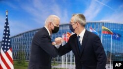 NATO Secretary General Jens Stoltenberg greets U.S. President Joe Biden with an elbow bump prior to a bilateral meeting on the sidelines of a NATO summit at NATO headquarters in Brussels, June 14, 2021. 