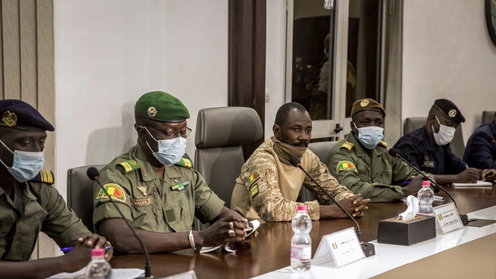 Col. Assimi Goita, center, who has declared himself the leader of the National Committee for the Salvation of the People, is accompanied by group spokesman Ismael Wague, left, as they meet with ECOWAS on Aug. 22, 2020.