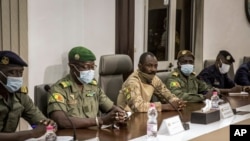 Col. Assimi Goita, center, who has declared himself the leader of the National Committee for the Salvation of the People, is accompanied by group spokesman Ismael Wague, left, as they meet with ECOWAS on Aug. 22, 2020.