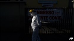 A health worker in full protective gear walks outside the Del Norte Hospital, which is treating COVID-19 patients exclusively, in El Alto, Bolivia, July 8, 2020.