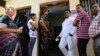An Indian paramilitary soldier stands guard as voters wait at a polling station in Bangalore, India, May 12, 2018. India's southern state of Karnataka headed to the polls to elect 224 lawmakers.