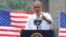 With the Key Bridge, linking Washington and Northern Virginia in the background, President Barack Obama speaks about the economy and transportation at Georgetown Waterfront Park in Washington, July 1, 2014.