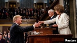 President Donald Trump, before delivering the State of the Union address, shakes the hand of Speaker of the House Nancy Pelosi. Vice President Mike Pence, center, is also in attendance at the Capitol in Washington, February 5, 2019. (Doug Mills/Pool via REUTERS)