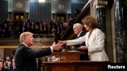 President Donald Trump, before delivering the State of the Union address, shakes the hand of Speaker of the House Nancy Pelosi. Vice President Mike Pence, center, is also in attendance at the Capitol in Washington, February 5, 2019. 