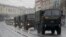 FILE - Police vehicles drive through a street during an opposition rally in Minsk, Belarus, March 25, 2017. A cordon of club-wielding police blocked the demonstrators' movement along Minsk's main avenue near the Academy of Science. Hulking police detention truck