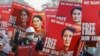 Demonstrators hold placards with the image of Aung San Suu Kyi during a protest against the military coup, in Naypyitaw, Myanmar, Feb. 17, 2021.