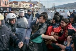 Migrants scuffle with Greek police at the port of Mytilene after locals block access to the Moria refugee camp, on the northeastern Aegean island of Lesbos, Greece, March 3, 2020.