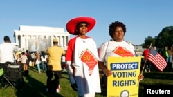 Marchers pose for pictures as they commemorate the 50th anniversary of the 1963 March on Washington for Jobs and Freedom at the Lincoln Memorial in Washington Aug. 2013. 