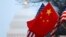 FILE - The People's Republic of China flag and the U.S. flag fly along Pennsylvania Avenue near the U.S. Capitol during Chinese President Hu Jintao's state visit in Washington, D.C., Jan. 18, 2011.