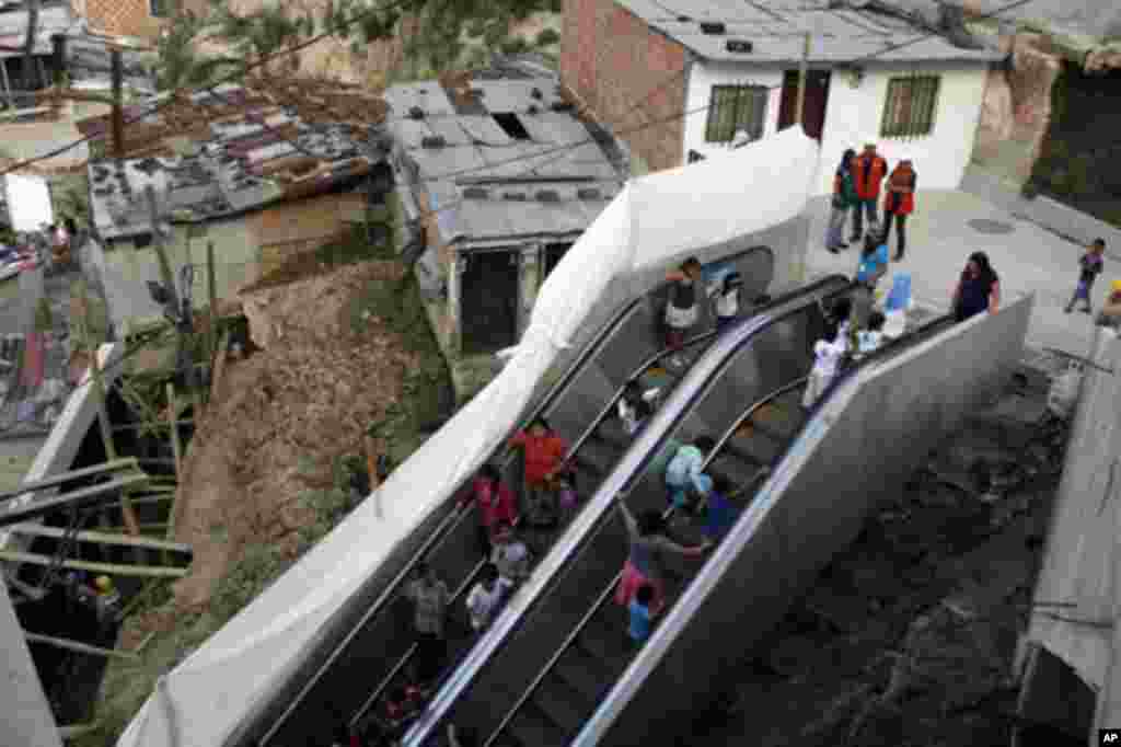 People travel on an outdoor public escalator at Commune 13 in Medellin January 12, 2012.