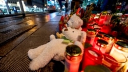 Sebuah boneka beruang diletakkan bersama lilin di dekat pasar Natal di Magdeburg, Jerman, lokasi insiden mobil yang menabrak kerumunan pada Jumat malam, 22 Desember 2024. (Foto: AP)