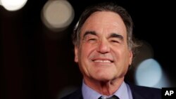 FILE - Director Oliver Stone arrives for the screening of his movie "Snowden," at the Rome Film Festival, in Rome. Showtime aired a series of interviews between Stone and Russian President Vladimir Putin over four days in June 2017.