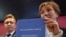Marina Litvinenko, widow of ex-KGB agent Alexander Litvinenko, poses with a copy of "The Litvinenko Inquiry" with her son, Anatoly, during a news conference in London, Jan. 21, 2016. 